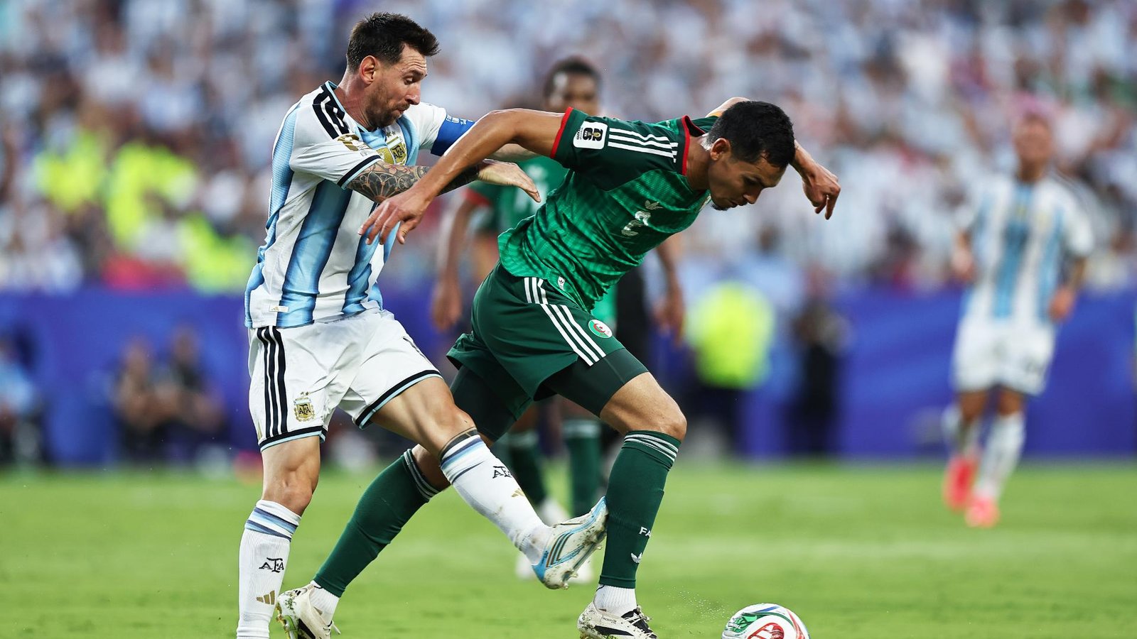 Lionel Messi challenges an Algeria defender during Argentina’s 2026 World Cup opener
