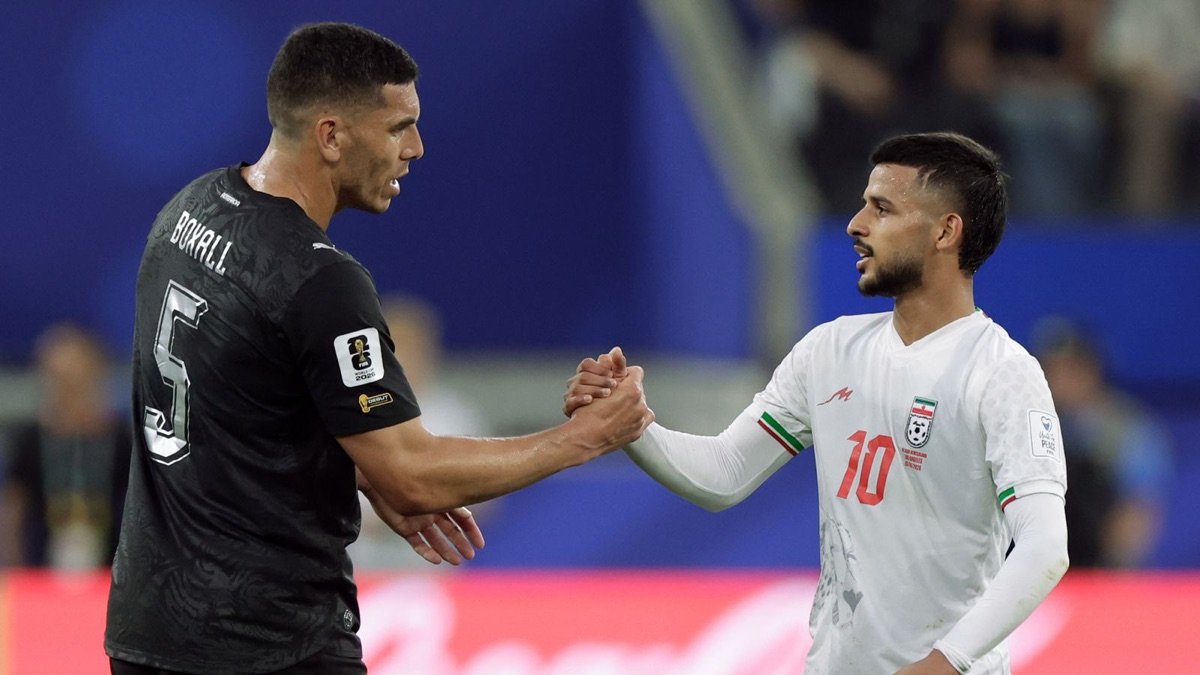 New Zealand and Iran players shake hands during their 2-2 World Cup Group G draw